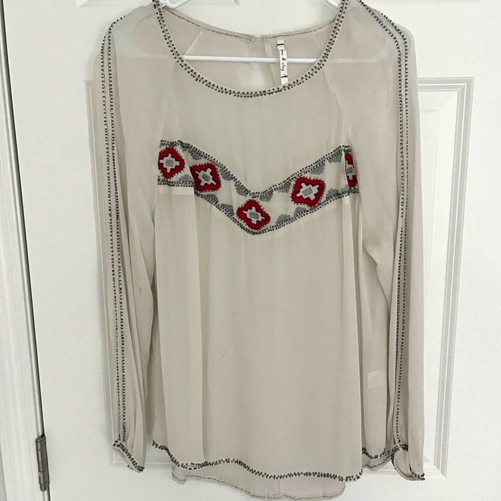 White blouse with pink and beading details